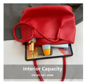 Internal capacity of red litchi leather tote bag showing tablet and cosmetics