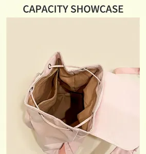 Internal view of a pink drawstring backpack showing large capacity and brown lining