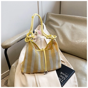Detail of yellow and white striped mesh tote bag with eco-friendly woven texture