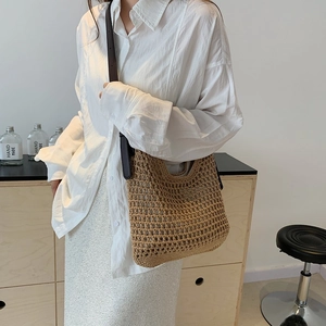 Detail of hand-woven hollow mesh texture on brown shoulder bag for beach vacation