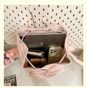 Top view of pink travel backpack interior showing large capacity for laptop and essentials