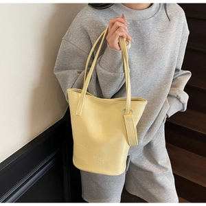 Detail of stone pattern oil wax leather bucket bag with silver metal ring and thin straps