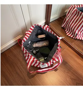 Interior view of striped canvas tote bag showing large capacity for daily essentials