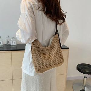 Detail of hand-woven crochet mesh texture and slim strap on khaki summer tote bag