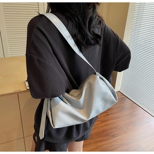 Detailansicht der hellblauen weichen Ledertasche mit Faltenstruktur an einem Model