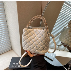 Dettaglio della borsa a secchiello trapuntata bianca con strass e manico intrecciato