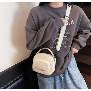 Detail of off-white canvas crossbody bag with OXUANMAO letter embroidery and wide strap