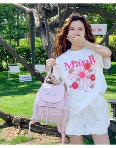 Pink casual backpack with MOFANLUO embroidery shown in an outdoor camping lifestyle setting