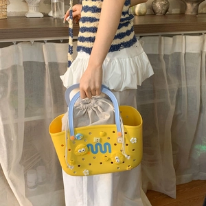 Macro detail of yellow EVA bathroom basket with light blue handles and drawstring inner bag