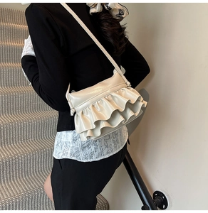 Detail of beige ruffled shoulder bag with pleats and smooth PU leather finish