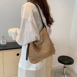 Detail of woven mesh beach tote bag with premium brown leather shoulder strap