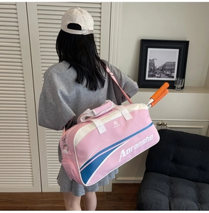 Pink sports bag detail with racquet storage and adjustable shoulder strap worn by model