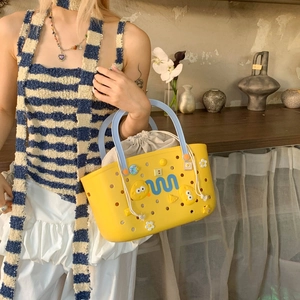 Detail of yellow hollow shower caddy bag with DIY charms and inner drawstring pouch