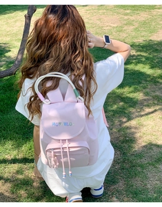 Detail of pink backpack with rabbit ears, white rope handles, and MOFANLUO logo