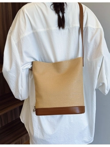 Straw woven bucket bag with brown leather base and strap for women in summer style
