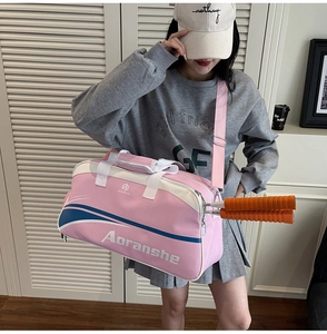 Pink and white badminton gym bag showing side pockets for rackets and padded handles