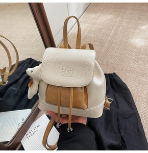 Detail of mini colorblock bucket backpack with wrinkled PU leather and bear charm