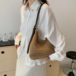 Detail of woven mesh shoulder bag featuring dark brown adjustable leather strap