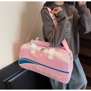 Pink multipurpose sports bag with blue stripes shown being carried by a model
