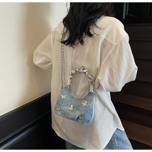 Light blue denim shoulder bag featuring silver butterfly decals and a metallic chain strap