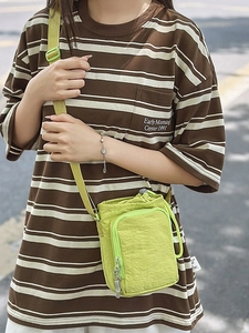 Neon green nylon water bottle crossbody bag with adjustable strap for outdoor use