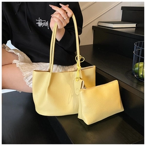 Detail of bright yellow litchi pattern tote bag and matching pouch in set