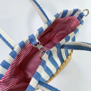 Detail view of the striped tote bag showing the interior lining and silver turn-lock clasp