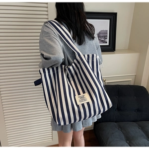 Close-up of a striped canvas tote bag showing the ROSTORY CHILD label and thick fabric