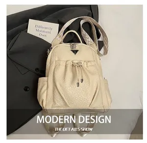 Detail of cream-colored backpack with lychee texture and geometric jacquard strap