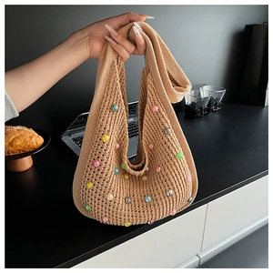 Detail view of khaki knit tote bag featuring colorful faux pearl bead embellishments
