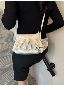 Chic beige crossbody bucket bag with pleated double ruffle layers and glossy finish