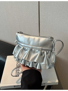 Metallic silver crossbody bucket bag with stylish double ruffle layers and zipper closure