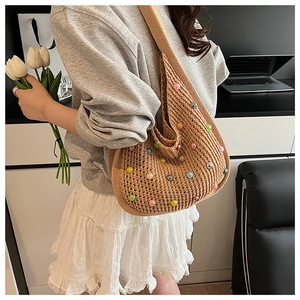 Detail of hobo shoulder bag with colorful beads and beige crochet knit texture