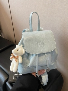 Chic light blue glossy leather bucket backpack with plush bear and drawstring