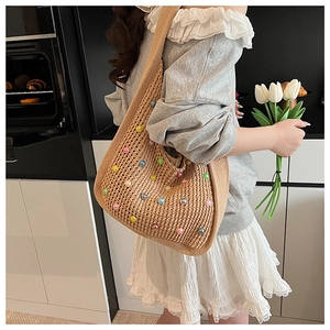 Detail of hand-woven shoulder bag with colorful beads and minimalist texture