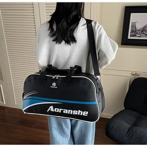 Rear view of a model wearing a large black fitness bag with blue accents and a strap