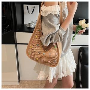 Detail of hand-crocheted shoulder bag featuring colorful 3D balls and lazy-style texture