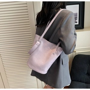 Detail of light purple crocodile embossed bucket bag made of premium oil wax leather