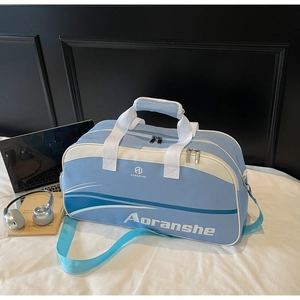 Large blue travel bag with handles and laptop accessories shown on a white bed