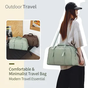 Detail of a minimalist canvas travel bag with adjustable shoulder strap in mint green