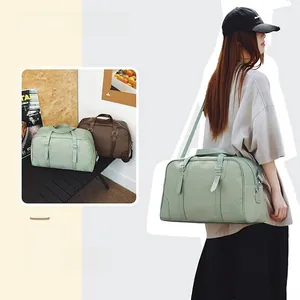 Detail of a minimalist canvas travel bag with adjustable shoulder strap in mint green