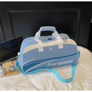 Light blue and white duffel bag with adjustable strap and handles on a bed