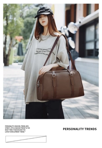 Brown vintage faux leather travel bag with adjustable strap and metallic buckles