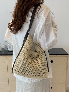 Bohemian hollow woven tote bag with brown leather straps shown in a lifestyle setting