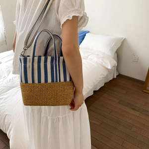 Detail of canvas stripe and straw patchwork tote bag with detachable crossbody strap