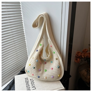 Detailed knit shoulder bag with colorful pearl accents and hobo style weave texture