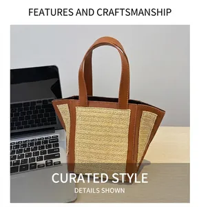 Detailed view of straw woven tote with brown leather handles next to a laptop