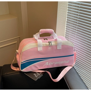 Pink canvas fitness bag with brand logo on a black chair under soft window light