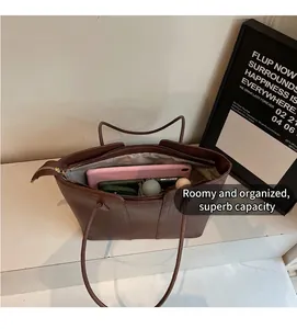 Détail intérieur du grand sac cabas en cuir marron montrant l'espace pour ordinateur