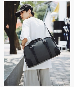 Detail of water-resistant gray travel bag featuring reinforced straps and crossbody strap